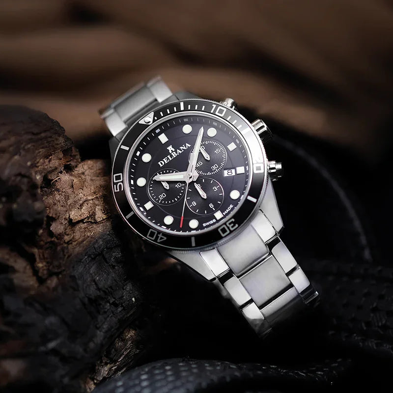 Silver watch with a black dial on a dark background