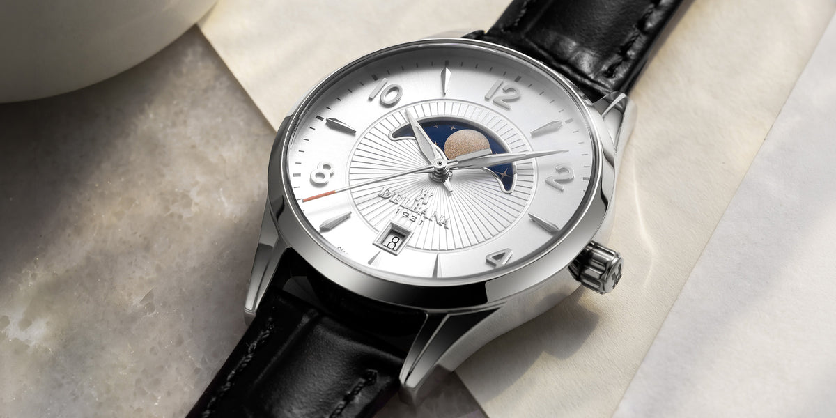 Delbana Lunetta stainless steel moonphase watch with silver dial and black leather strap in context