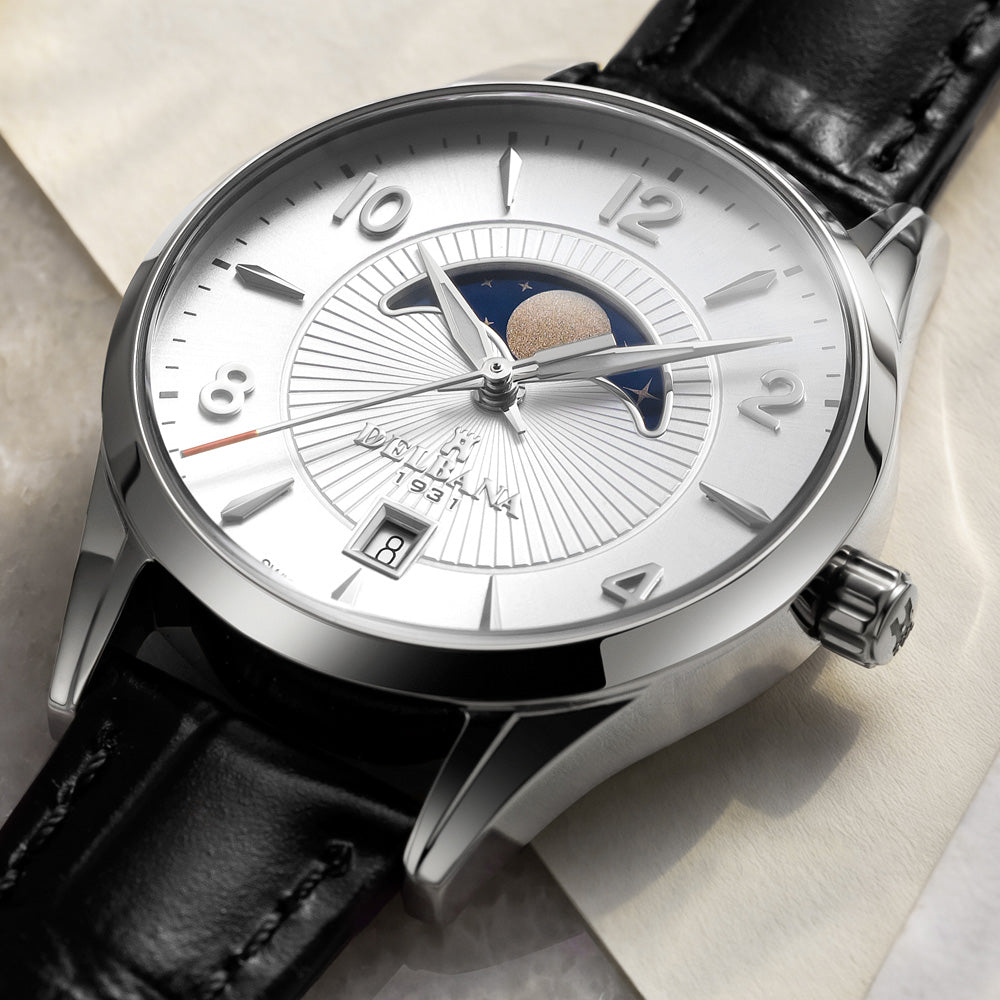 Delbana Lunetta stainless steel moonphase watch with silver dial and black leather strap in context close up