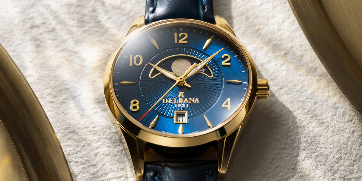 Delbana Lunetta stainless steel with yellow gold PVD moonphase watch with blue dial and blue leather strap in context