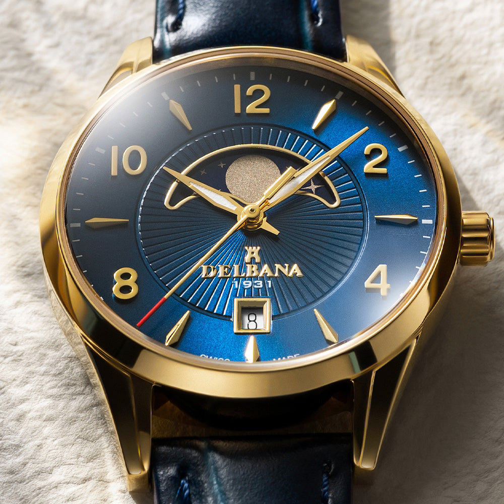 Delbana Lunetta stainless steel with yellow gold PVD moonphase watch with blue dial and blue leather strap close up
